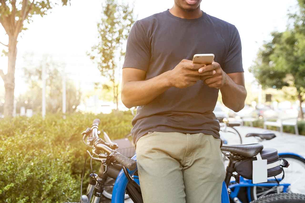 men scrolling through his phone | Infront