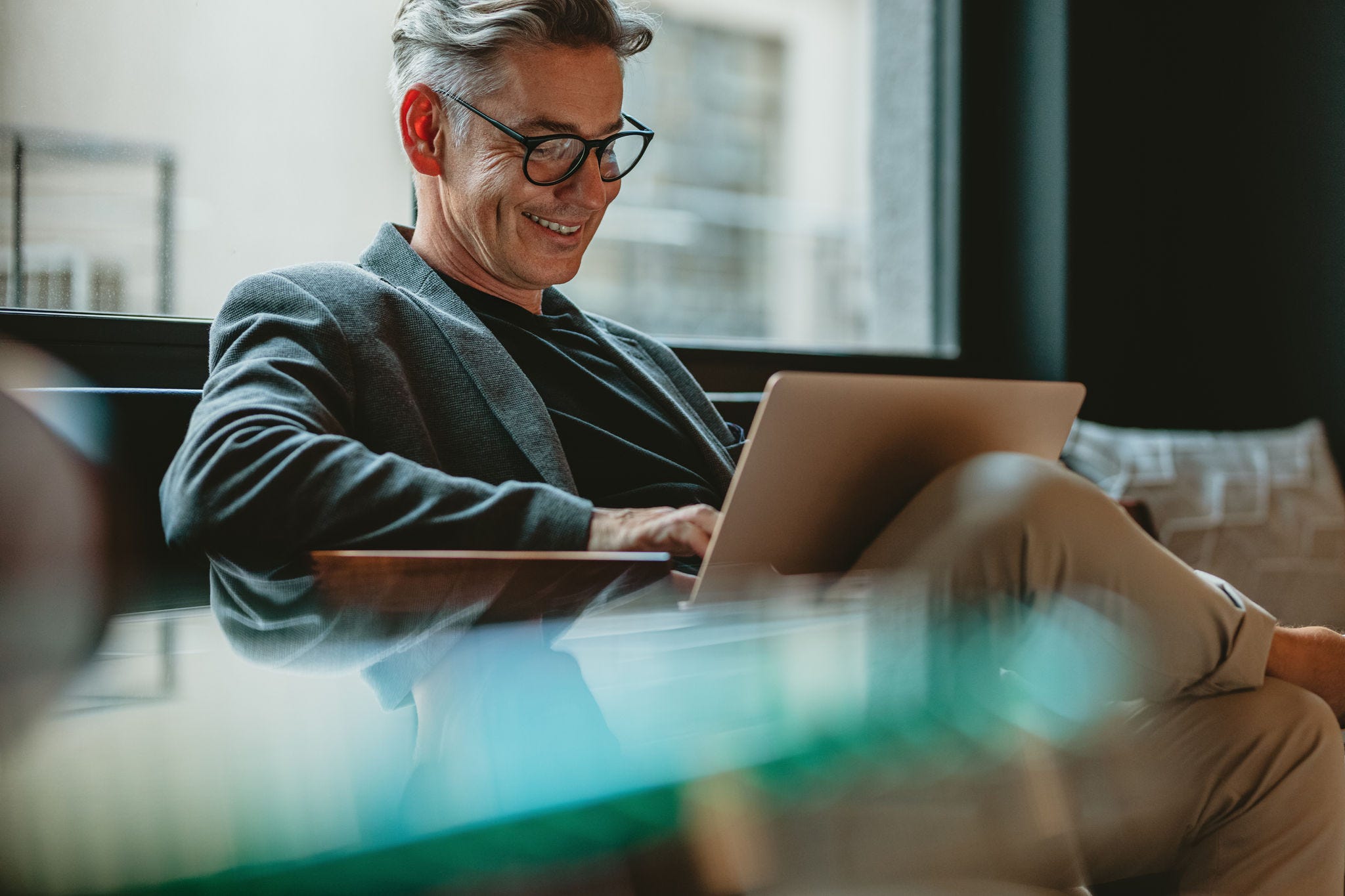 Man sitting reading on laptop